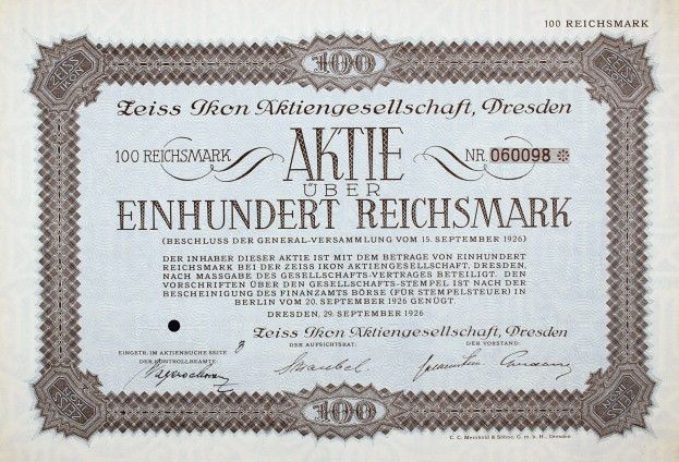 Altes deutsches Aktienzertifikat über 100 Reichsmark mit schwarzem Rand und deutscher Beschriftung.