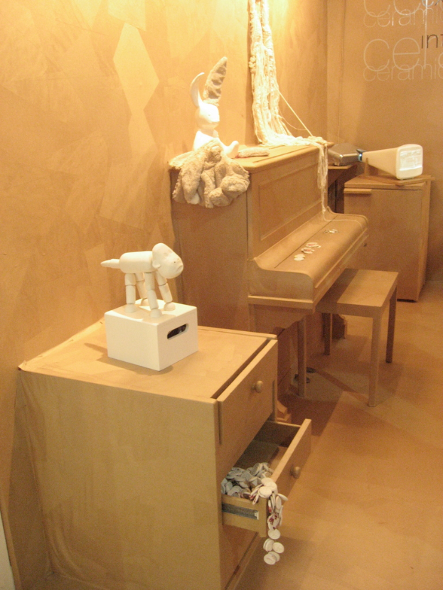 Ein Raum mit Schränken, einer Tastatur, einigen Spielzeugen und einer Wand.